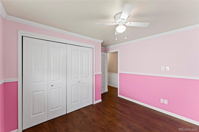 unfurnished bedroom featuring ornamental molding, a closet, dark wood finished floors, and baseboards