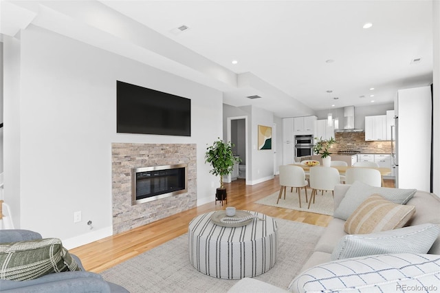 1284 Tennyson St Unit 1, Denver, CO 80204 - living area featuring light wood-style floors, recessed lighting, and a glass covered fireplace