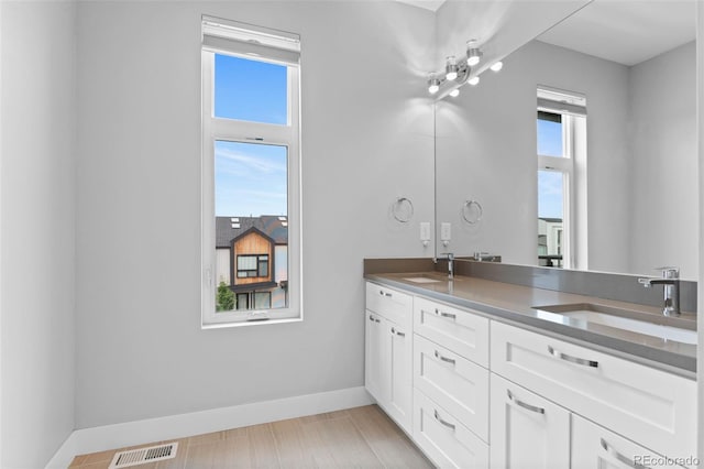 1284 Tennyson St Unit 1, Denver, CO 80204 - full bathroom featuring double vanity and baseboards