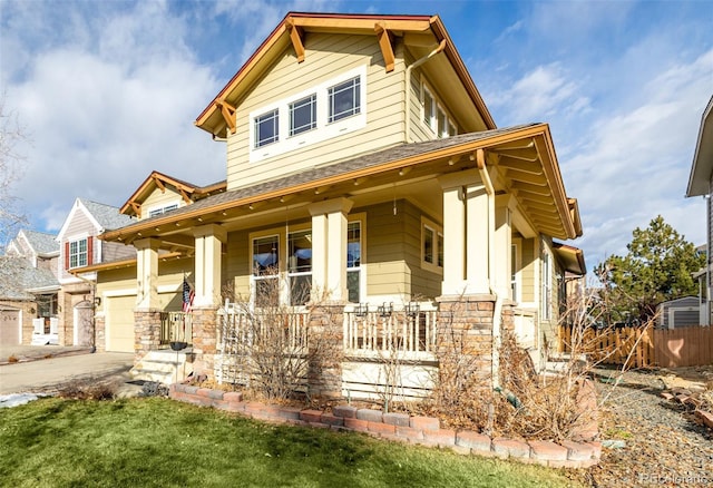 craftsman inspired home with covered porch and a garage