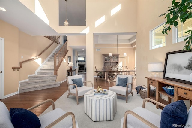 living room featuring a high ceiling and hardwood / wood-style flooring