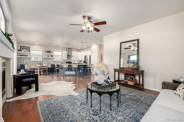 living room with ceiling fan and dark hardwood / wood-style flooring