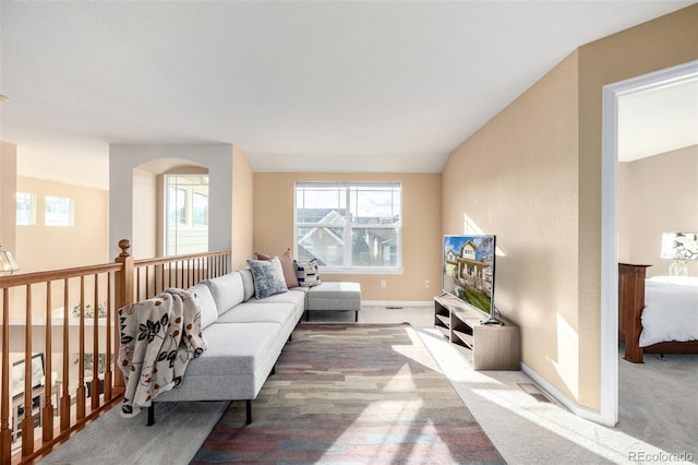 carpeted living room featuring vaulted ceiling