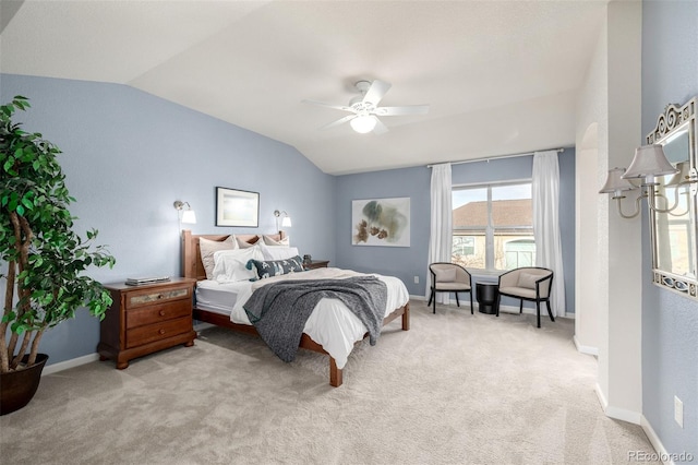 bedroom with ceiling fan, vaulted ceiling, and light carpet