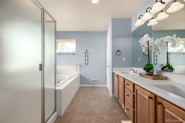 bathroom with independent shower and bath, tile patterned flooring, and vanity