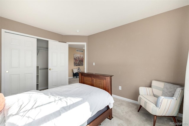 bedroom featuring a closet and light carpet