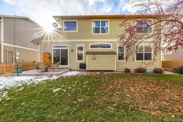 back of property featuring a yard and a patio