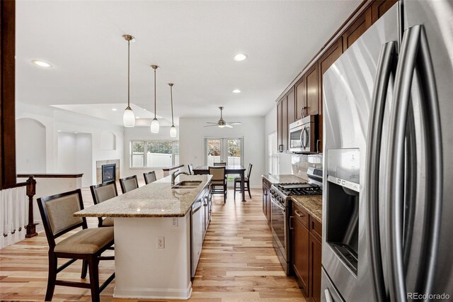 4400 S Ensenada St, Aurora, CO 80015 - kitchen featuring appliances with stainless steel finishes, a sink, ceiling fan, light wood finished floors, and recessed lighting