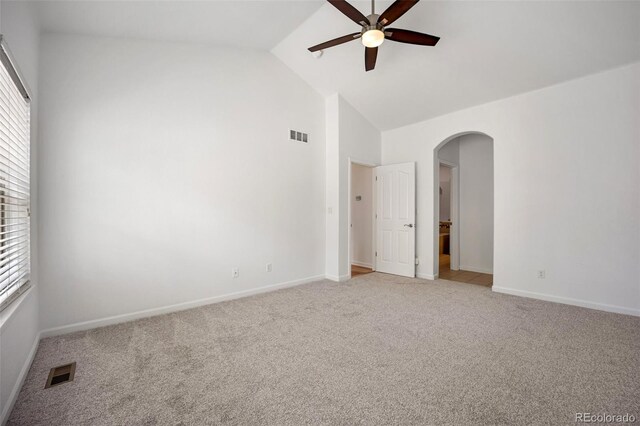 4400 S Ensenada St, Aurora, CO 80015 - unfurnished room with ceiling fan, arched walkways, light carpet, baseboards, and high vaulted ceiling