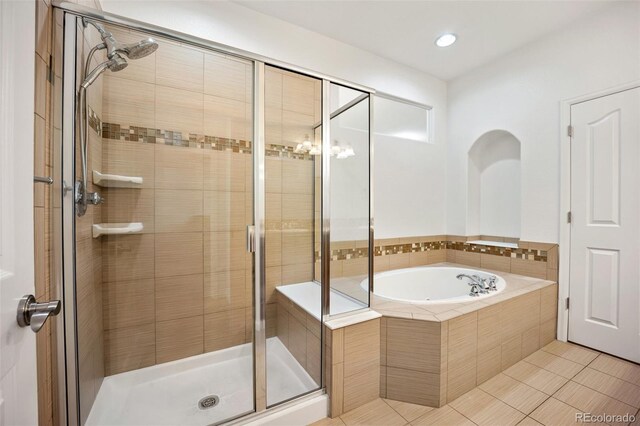 4400 S Ensenada St, Aurora, CO 80015 - full bath featuring a bath, a stall shower, tile patterned flooring, and recessed lighting