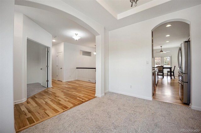 4400 S Ensenada St, Aurora, CO 80015 - unfurnished room featuring arched walkways, light wood finished floors, recessed lighting, a ceiling fan, and baseboards