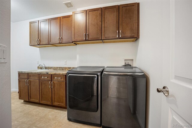 4400 S Ensenada St, Aurora, CO 80015 - laundry area featuring washer and clothes dryer, cabinet space, light tile patterned floors, and baseboards