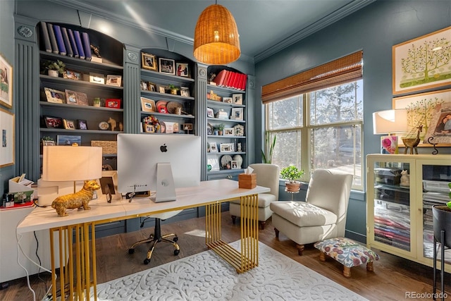 office area with built in shelves, crown molding, and hardwood / wood-style floors