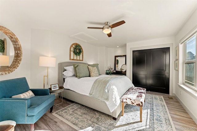 bedroom with light hardwood / wood-style floors and ceiling fan