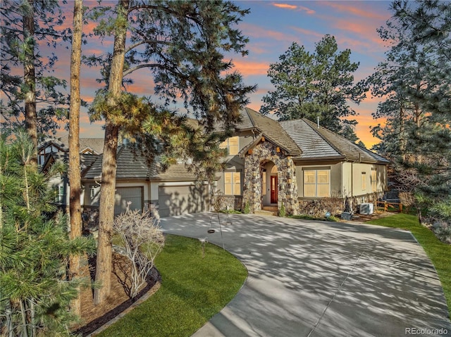 view of front of home featuring cooling unit and a garage