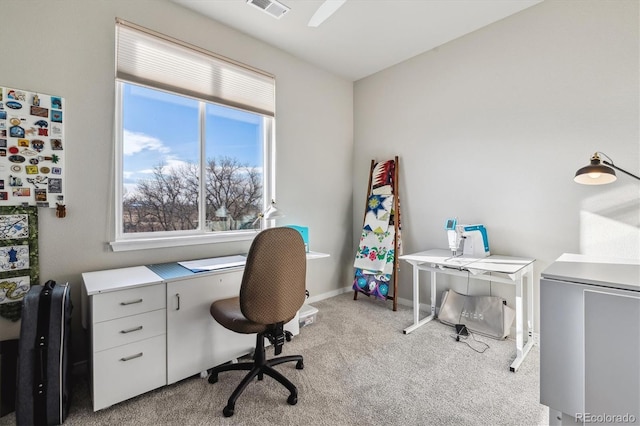 office space with carpet flooring, baseboards, and visible vents