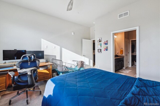 bedroom with visible vents, carpet floors, and ensuite bathroom