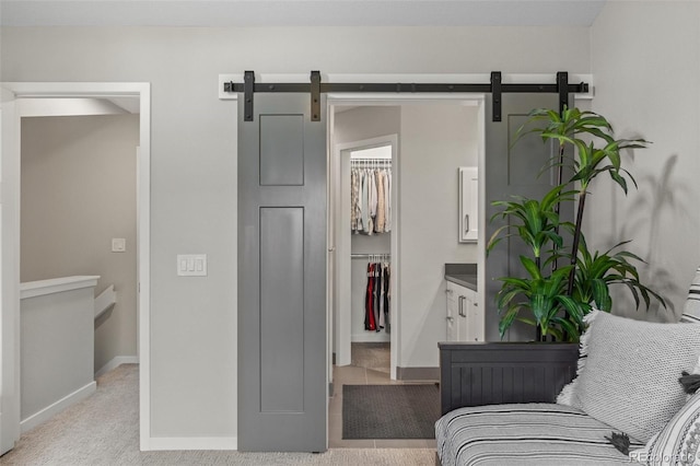 2528 Concord Cir, Lafayette, CO 80026 - bedroom featuring a spacious closet, a barn door, and a closet