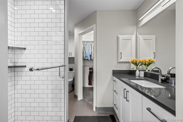 2528 Concord Cir, Lafayette, CO 80026 - full bath with vanity, tile patterned floors, a spacious closet, and a shower
