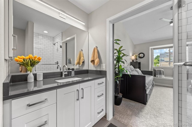 2528 Concord Cir, Lafayette, CO 80026 - full bathroom with vanity, a tile shower, ensuite bath, and lofted ceiling