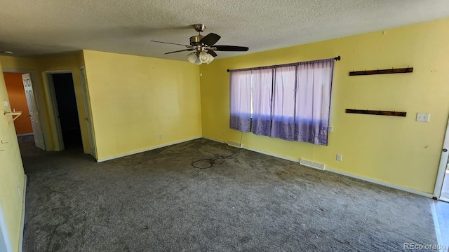 carpeted spare room featuring ceiling fan and a textured ceiling