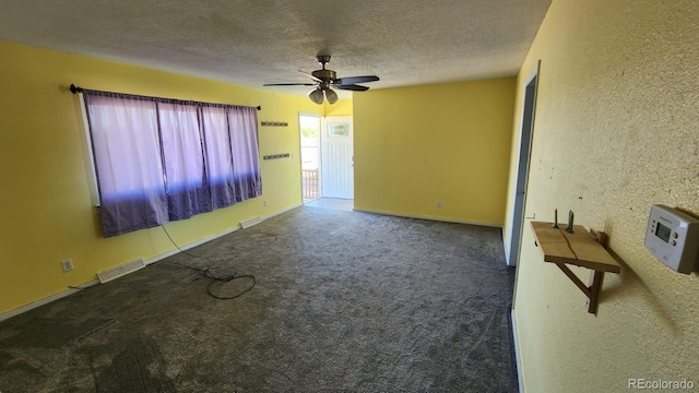 unfurnished room with ceiling fan, carpet flooring, and a textured ceiling