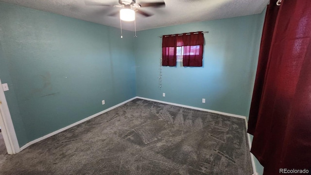 carpeted spare room with a textured ceiling and ceiling fan