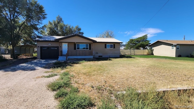 ranch-style home featuring a garage, a front lawn, and a carport