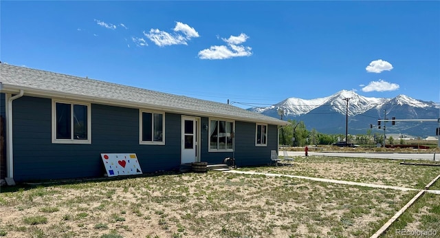 98 Baylor Dr, Buena Vista, CO 81211 - rear view of house featuring a mountain view, entry steps, and a lawn