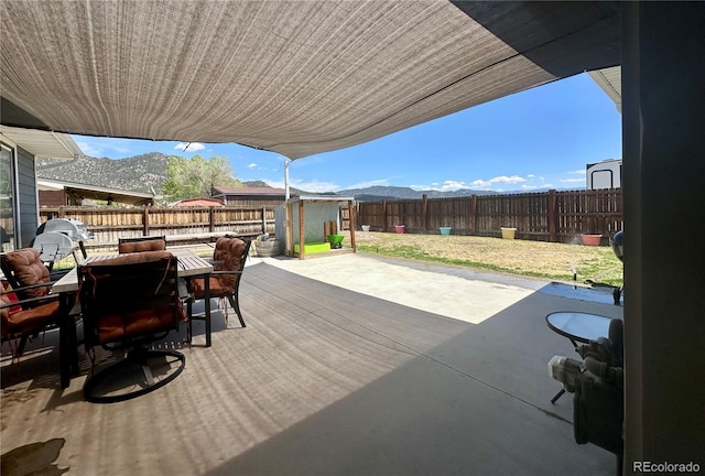 98 Baylor Dr, Buena Vista, CO 81211 - fenced backyard with outdoor dining area, a patio, and a mountain view