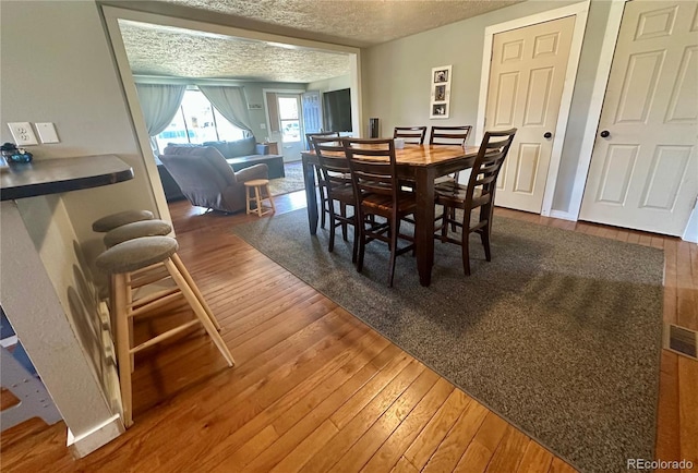 98 Baylor Dr, Buena Vista, CO 81211 - dining area with hardwood / wood-style flooring and a textured ceiling