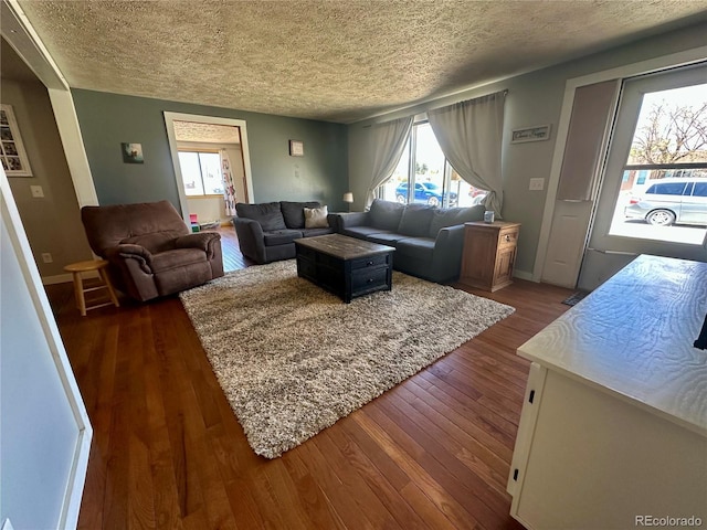 98 Baylor Dr, Buena Vista, CO 81211 - living room with a textured ceiling, plenty of natural light, dark wood-style flooring, and baseboards