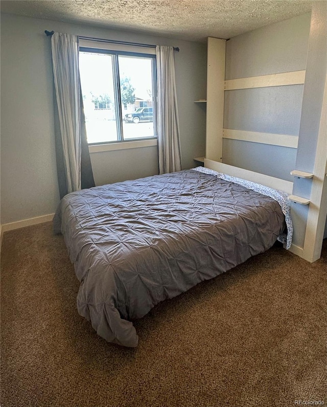 98 Baylor Dr, Buena Vista, CO 81211 - carpeted bedroom with a textured ceiling and baseboards