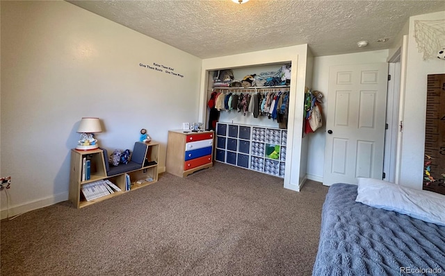 98 Baylor Dr, Buena Vista, CO 81211 - bedroom featuring a textured ceiling, carpet flooring, a closet, and baseboards