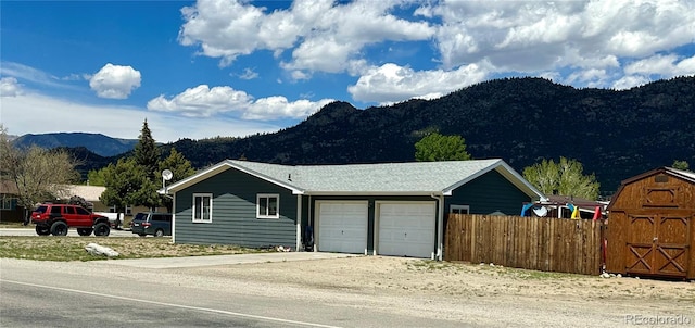 98 Baylor Dr, Buena Vista, CO 81211 - view of front of house with a mountain view, a garage, and driveway