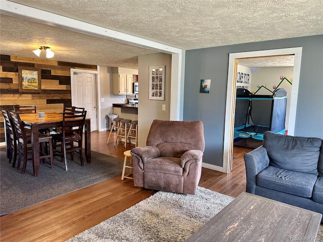 98 Baylor Dr, Buena Vista, CO 81211 - living area featuring wood finished floors, a textured ceiling, and baseboards