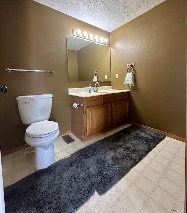98 Baylor Dr, Buena Vista, CO 81211 - bathroom with toilet, a textured ceiling, vanity, and baseboards