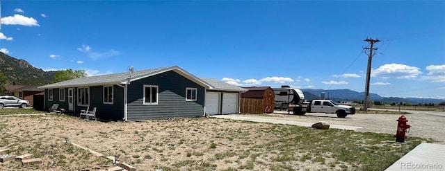 98 Baylor Dr, Buena Vista, CO 81211 - view of home's exterior with a mountain view, concrete driveway, and an attached garage