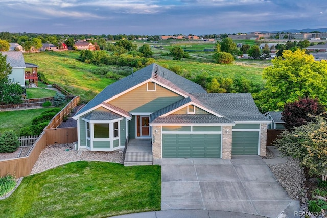 1838 Mountain Daisy Ct, Highlands Ranch, CO 80129 - view of front of house featuring a garage, a fenced backyard, concrete driveway, and roof with shingles