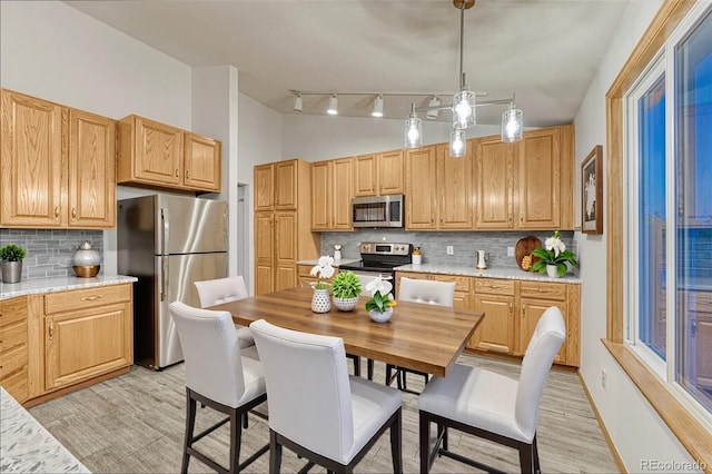 1838 Mountain Daisy Ct, Highlands Ranch, CO 80129 - kitchen featuring stainless steel appliances, tasteful backsplash, light countertops, light wood-style floors, and a towering ceiling
