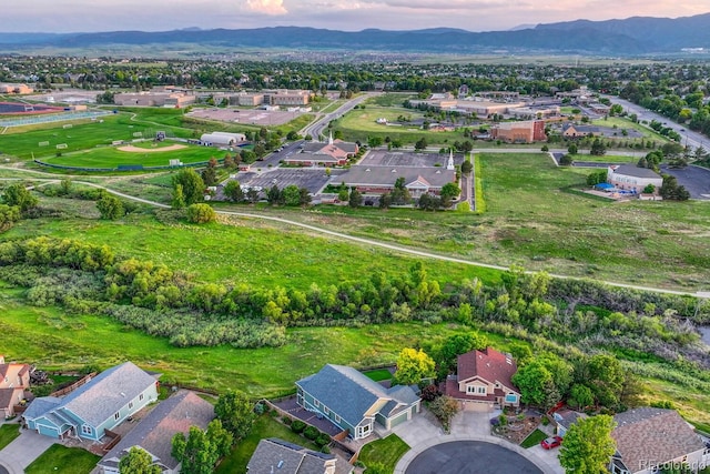 1838 Mountain Daisy Ct, Highlands Ranch, CO 80129 - aerial view of property's location featuring a mountainous background and nearby suburban area