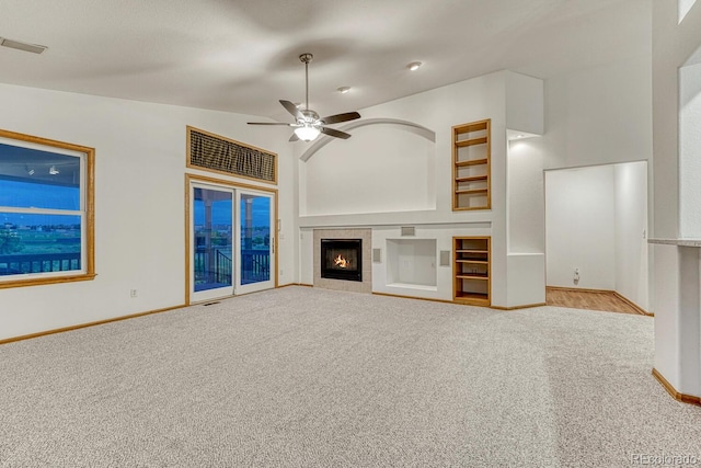 1838 Mountain Daisy Ct, Highlands Ranch, CO 80129 - unfurnished living room featuring carpet, a ceiling fan, a tile fireplace, baseboards, and vaulted ceiling