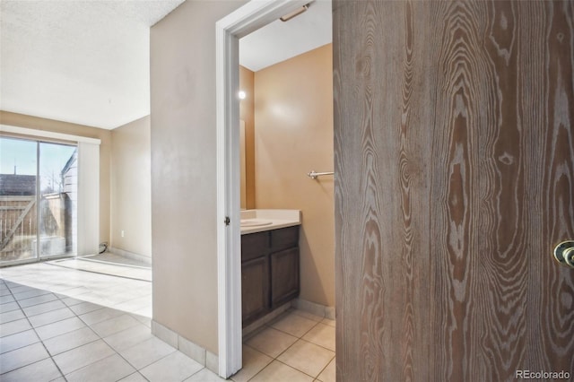 bathroom featuring tile patterned floors, vanity, and a textured ceiling