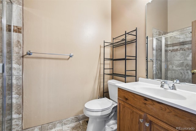 bathroom featuring tile patterned flooring, vanity, an enclosed shower, and toilet