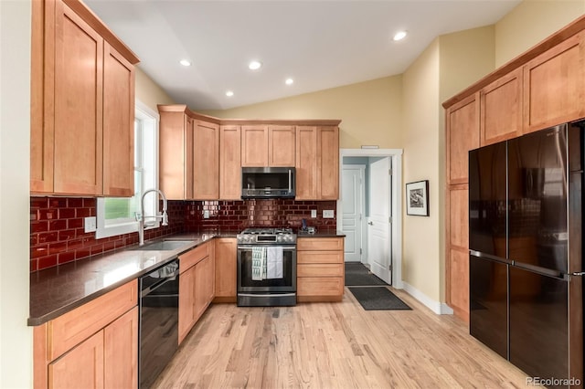 19500 Wedemeyer Rd, Kiowa, CO 80117 - kitchen with black appliances, light brown cabinets, decorative backsplash, vaulted ceiling, and light wood-style flooring