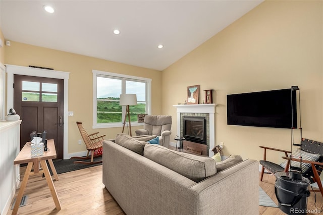19500 Wedemeyer Rd, Kiowa, CO 80117 - living room featuring light wood-style floors, a glass covered fireplace, recessed lighting, and lofted ceiling