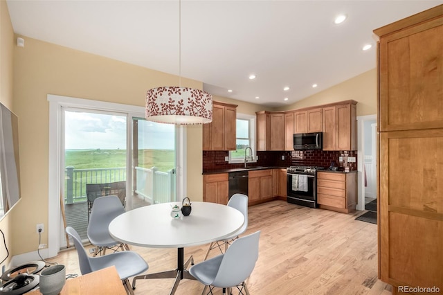 19500 Wedemeyer Rd, Kiowa, CO 80117 - kitchen featuring range with gas cooktop, backsplash, lofted ceiling, light wood-type flooring, and dark countertops