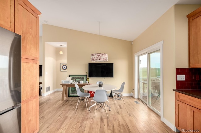 19500 Wedemeyer Rd, Kiowa, CO 80117 - dining area featuring vaulted ceiling and light wood-style floors