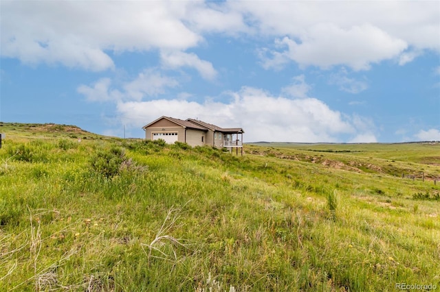 19500 Wedemeyer Rd, Kiowa, CO 80117 - view of yard featuring a garage and a view of countryside
