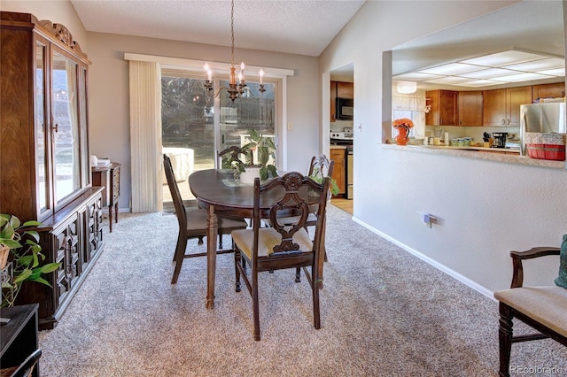 dining area featuring lofted ceiling, light colored carpet, a notable chandelier, and a textured ceiling